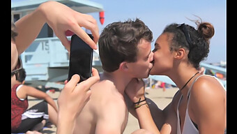 African American Girl Kisses White Boy On The Beach